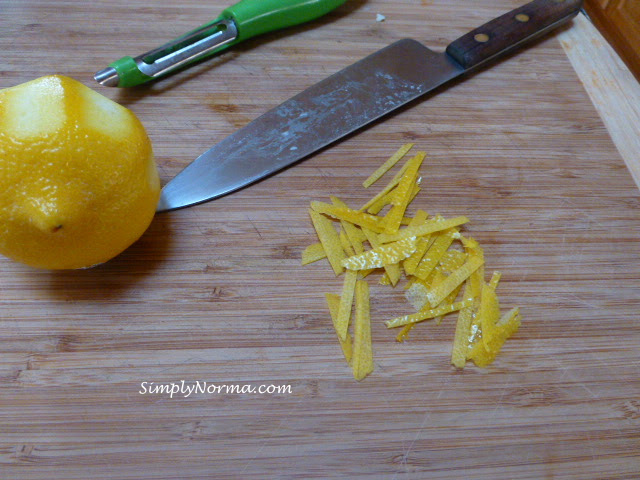 Grate chunks of lemon then slice thinly